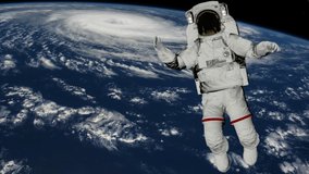 Astronaut Spacewalk, Astronaut shows thumbs up in the open space. Earth with a Hurricane. Elements of this video furnished by NASA.