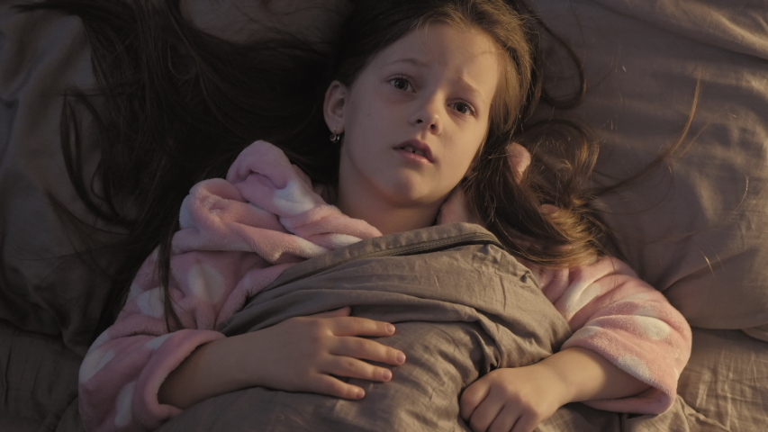 Child insomnia. Anxiety fear. Scared young girl in bed disturbed with fantasy monster at night. Royalty-Free Stock Footage #1052105545