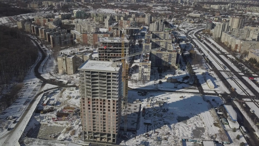 Lviv, Sychiv, Ukraine - 2 7 2020: Tower cranes work during the construction of a multi-story building. New apartments for residents and premises for offices. Risky work at height. | Shutterstock HD Video #1052114098