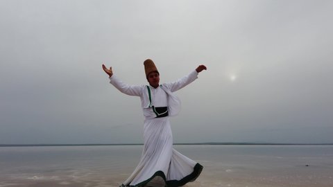 sunset and whirling at the sea, sufi. sufi whirling (Turkish: Semazen) is a form of Sama or physically active meditation which originated among Sufis. 4k