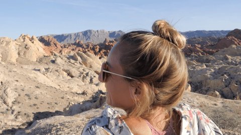 Sporty young woman contemplating wave red sandstone in Valley of fire state park in Las Vegas in Nevada, USA. Girl hiking in nature in the morning