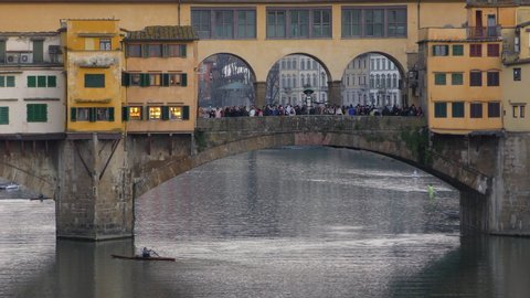 FLORENCE, ITALY - FEBRUARY 24, 2020: Bridge Ponte Vecchio on Arno river. Early morning in Florence, Italy. Slow zoom out.