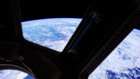 ISS porthole and the Planet Earth. Elements of this video furnished by NASA.