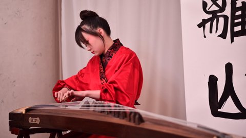 ST. PETERSBURG, RUSSIA - NOVEMBER 13, 2019: Xie Xiaocao plays guzheng, Chinese traditional plucked string instrument during presentation in Faberge Museum as part of St. Petersburg Cultural Forum