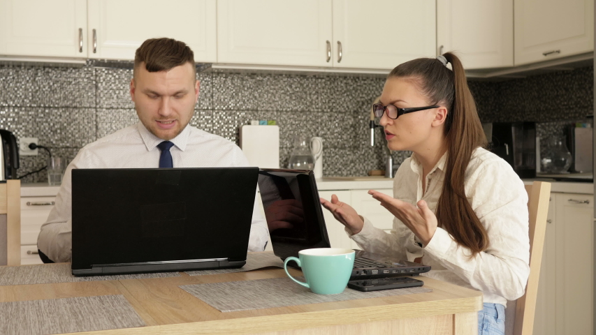 Online business.Young married couple working at home. Spouses argue.