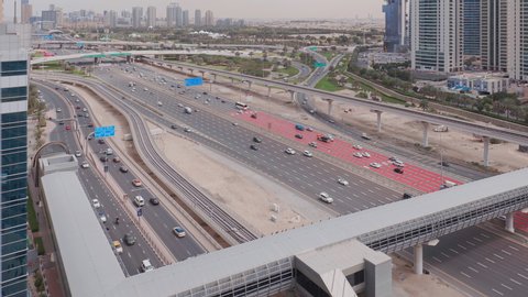 Aerial view of empty highway and interchange in Dubai after epidemic lockdown. Cityscapes with disappearing traffic on streets. Roads and lanes crossroads without cars in Dubai Marina and JLT, United