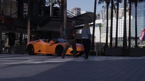 Sydney / Australia - 09 01 2018: Lamborghini Huracan Pulling Up to a Crosswalk in Front of a Hard Rock Cafe. Slow Motion.