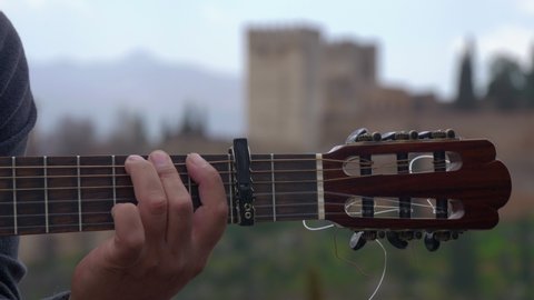 Close-up of the hand of a street flamenco guitarist playing the guitar in the viewpoint of San Nicolas. Albaicin Granada.