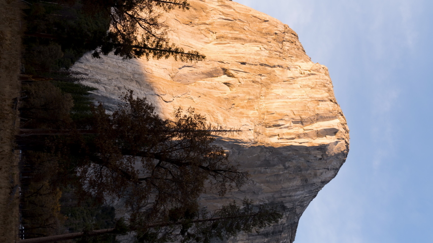 Vertical Time Lapse of El Capitan Yosemite National Park at Sunset with Clouds Passing by and sun shadow on rock face