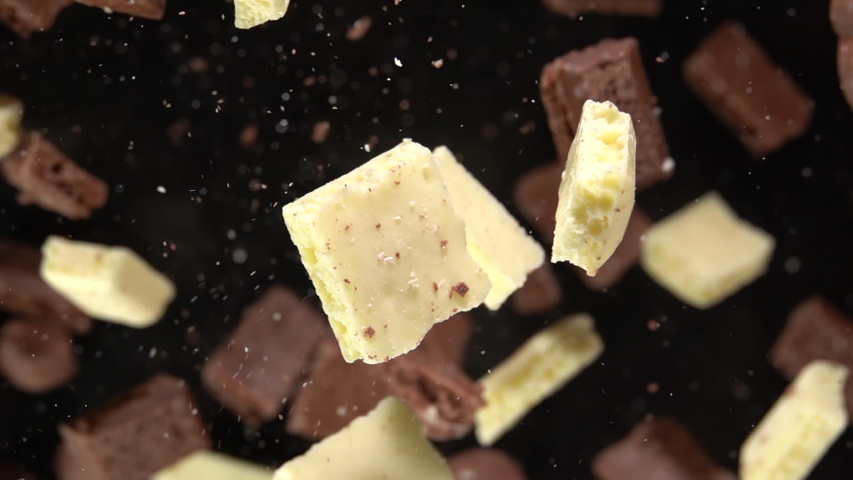 Explosion of pieces of chocolate on camera. Slow Motion 250fps