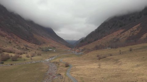 DRONE FOOTAGE - The upper Neste d'Oô valley widens in the Val d'Astau, just downstream from a chain of magnificent mountain lakes. Valley near Granges d'Astau in the French Pyrenees. 