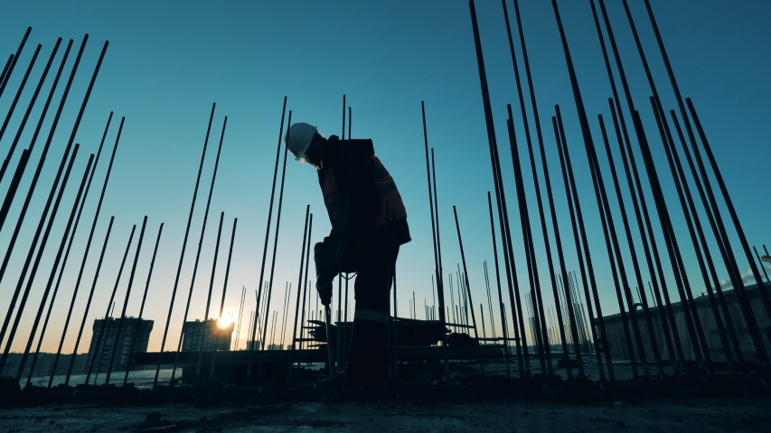 Male constructor is using a jackhammer to demolish concrete | Shutterstock HD Video #1052163967