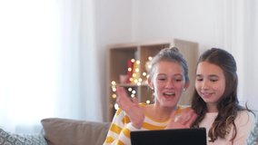 people, technology and friendship concept - happy teenage girls with tablet computer having video chat at home