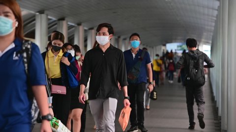 4K Crowded asian people wear face mask walking in pedestrian walkway