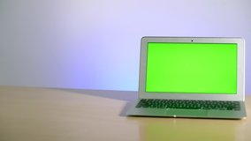 Man's hands put a sanitizer or liquid soap next to a laptop with a green screen. Stay home to work with a laptop on the screen of which chromakey. Coronavirus or covid-19