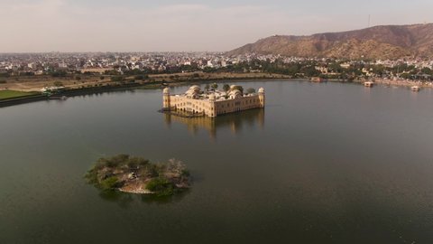 Jal Mahal Water Palace Jaipur. Pink city aerial panoramic. Sunset 4k footage of beautiful skyline in historic city.  Palace on Man Sagar lake in Japur, Rajasthan, India