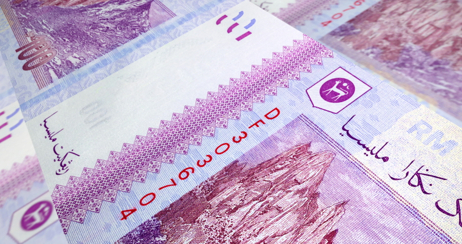 Tracking shot over one hundred Ringgit Malaysia. Detailed macro capture of brand new RM 100 with sequential number. Macro shot from the back of Malaysian money with the picture of Mount Kinabalu. | Shutterstock HD Video #1052193661