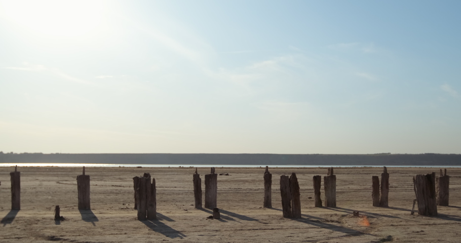 Two guys with the UK and USA flags ride on gyroboards along the corridor of pillars. The America catches up with the United Kingdom.