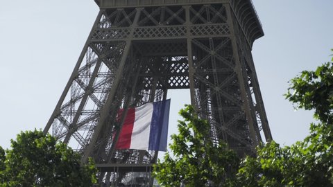 Paris, France - 05 11 2020: french flag waving in Eiffel tower as tribute to medical workers during coronavirus / Covid-19 quarantine 4K