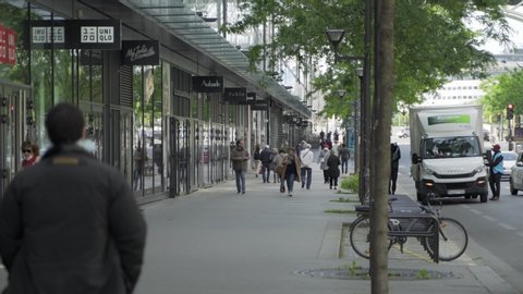 Paris, France - 05 11 2020: busy commercial street on first day after coronavirus / Covid-19 quarantine / lockdown  4K 