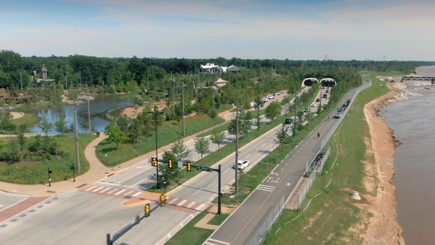 Tulsa, Oklahoma, USA. Aerial: The Gathering Place park & Riverside Drive along the Arkansas River.