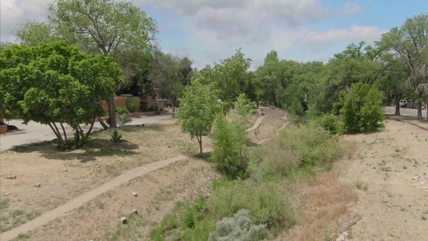 Santa Fe, New Mexico, USA. Aerial flying over a park &  houses in the desert city. 