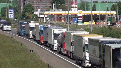 HAZELDONK, NETHERLANDS – 6 MAY 2020: Europe infrastructure and transportation issues due to coronavirus Covid-19 outbreak, huge traffic jam of cargo trucks at Dutch Belgian temporary border crossing 