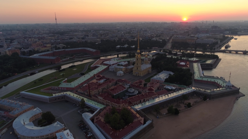 Epic cityscape St. Petersburg orange sunset sun. Peter and Paul historical island fortress. Oldest architectural monument symbol of city. Neva river. Scenic downtown. Russia cultural capital. Aerial