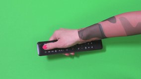 Woman using remote control on green