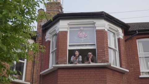 Harringay, London / UK - May 07 2020: Couple Clapping from their window. NHS Clap For Our Carers, Coronavirus Lockdown London. 