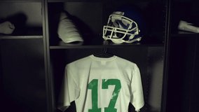 American Football Changing room / Locker room. All the kit or uniform is laid out ready for the players. Crane Shot. Stock Video Clip Footage
