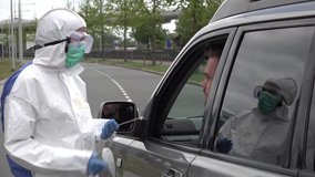 Health care worker in hazmat suit takes nasal sample from coronavirus Covid-19 patient in drive through testing clinic, reflection of doctor visible in the window
 - Powered by Shutterstock - Get 15% off with code: PIKWIZARD15