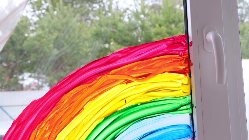 4k. large rainbow pattern on window during Covid-19 quarantine at home. Stay at home social media campaign for coronavirus prevention, let's all be well, hope. Chase the rainbow. | Shutterstock HD Video #1052292064