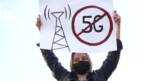 People take part to a protest against the 5G technology and 5G-compatible antenna deployment. Young student activist in a mask hold a poster. Strike during quarantine covid-19 - Powered by Shutterstock - Get 15% off with code: PIKWIZARD15