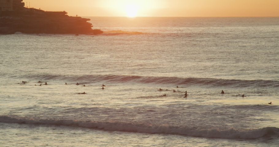 Surfers enjoying early morning waves at Bondi Beach. (Shot on RED) Royalty-Free Stock Footage #1052320582