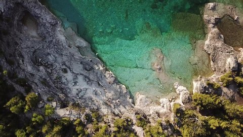Top Down Aerial View of Turquoise Lake Lagoon Under White Cliffs and Green Forest. Tobermory, Bruce Peninsula, Ontario, Canada