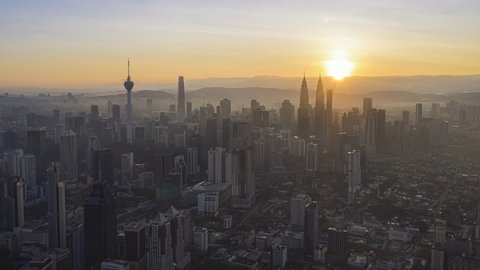 Aerial Time lapse: Kuala Lumpur city view during dawn overlooking the KL city skyline with the Petronas Towers and national landmarks in Federal Territory, Malaysia. Prores Full HD