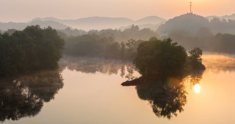 time lapse of misty river in the early morning, beautiful wuyuan landscape of moon bay in sunrise,  jiangxi province, China