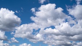 Beautiful 4k video timelapse of white clouds moving fast in blue sky. Natural background.