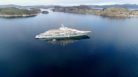 Stavanger / Norway - 03 11 2019: A Super Yacht anchored in a bay with islands in the background POI shot side to front