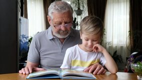 Grandfather senior man reading a book with his grandson - Powered by Shutterstock - Get 15% off with code: PIKWIZARD15