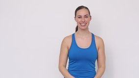 Video of fit young woman in sports wear cheering and feeling full of energy concept. 