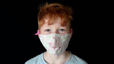 Portrait close up of Little red hair boy wearing face mask during coronavirus epidemic pandemic blue eyes aryan