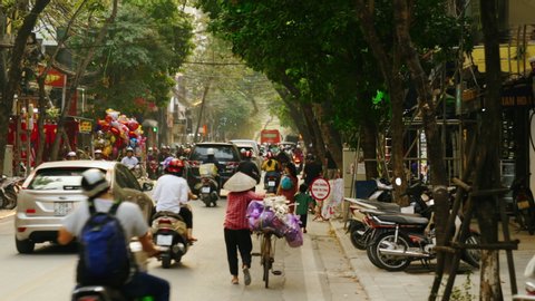 HANOI, VIETNAM - NOVEMBER 7, 2019: Rush Hour Traffic in the Old Quarter of Hanoi Vietnam