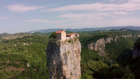 Katskhi pillar. Man's monastery near the village of Katskhi. The orthodox church and the abbot cell on a rocky cliff. Imereti, Georgia.