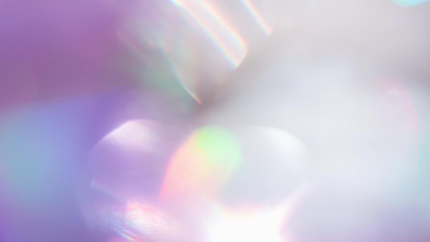 Optical Refraction in Violet Tones. Loop. The light passes through the facets of a slowly rotating diamond and creates repetitive sparkling highlights and rainbow colors