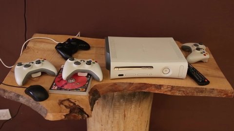 Saint-Petersburg, Russia, 05/05/2020: x-box 360 game console and four game consoles are on a wooden table