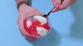 Woman mixing dessert cream on blue
