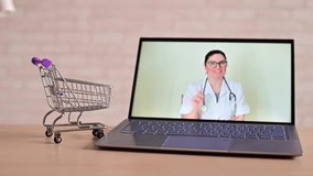 A friendly doctor gives a remote prescription on a laptop. The pharmacist adds a cure for the virus in the mini cart. Online medicine concept. Order drugs online. Video call.