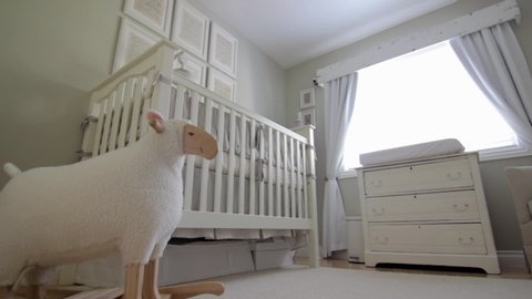New Born Baby's Nursery Bedroom with Crib, Chair, dresser and toy sheep, Tracking shot Interior Design for Children's Rooms